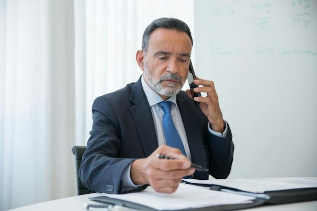 property manager speaking on the phone while sat at their desk